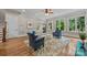 Bright living room featuring hardwood floors, a ceiling fan and large windows overlooking the yard at 914 Elizabeth Ln, Matthews, NC 28105