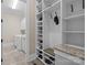 Organized mudroom with custom shelving, granite countertop, and adjacent laundry room featuring modern washer and dryer at 914 Elizabeth Ln, Matthews, NC 28105