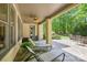 Covered patio with lounge chairs and ceiling fan offers a relaxing outdoor space overlooking a green yard at 914 Elizabeth Ln, Matthews, NC 28105