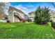 Backyard featuring a lush lawn, stairs to a deck, and mature trees, offering a private outdoor space at 10210 Roosevelt Dr, Huntersville, NC 28078