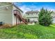 Backyard featuring a lush lawn, stairs to a deck, and mature trees, offering a private outdoor space at 10210 Roosevelt Dr, Huntersville, NC 28078