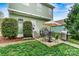 Backyard patio area with seating, grill, manicured landscaping and trees at 10210 Roosevelt Dr, Huntersville, NC 28078