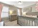 This bedroom features a gray crib, dresser, and neutral walls at 10210 Roosevelt Dr, Huntersville, NC 28078