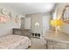 This bedroom features a gray crib, dresser, and neutral walls at 10210 Roosevelt Dr, Huntersville, NC 28078
