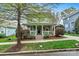 Charming two-story home with a welcoming front porch and well-maintained landscaping at 10210 Roosevelt Dr, Huntersville, NC 28078