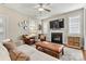 Inviting living room with a fireplace, comfortable seating, ceiling fan, and neutral decor at 10210 Roosevelt Dr, Huntersville, NC 28078