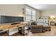 Functional office featuring a large desk, comfortable seating, and ample natural light at 10210 Roosevelt Dr, Huntersville, NC 28078