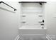 This bathtub features built-in shelving and matte black fixtures at 1033 Harrogate Dr, Bessemer City, NC 28016