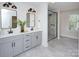 This bathroom features double sinks, grey cabinets, modern fixtures and a glass enclosed shower at 1033 Harrogate Dr, Bessemer City, NC 28016