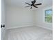 This carpeted bedroom features bright windows and a ceiling fan at 1033 Harrogate Dr, Bessemer City, NC 28016