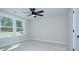 This carpeted bedroom features bright windows and a ceiling fan at 1033 Harrogate Dr, Bessemer City, NC 28016