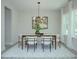 Bright dining room features a wooden table, white chairs, modern chandelier, and natural light at 1033 Harrogate Dr, Bessemer City, NC 28016