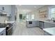 This open kitchen has stainless steel appliances, gray cabinets, and seamlessly connects to the dining room at 1033 Harrogate Dr, Bessemer City, NC 28016