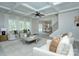 Open living room with coffered ceilings, modern furniture, and a view into the kitchen at 1033 Harrogate Dr, Bessemer City, NC 28016