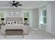 This main bedroom features a fan, neutral decor, bright windows and a bench at the foot of the bed at 1033 Harrogate Dr, Bessemer City, NC 28016