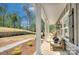 Inviting covered porch with seating, perfect for relaxing and enjoying the surrounding landscape at 1033 Harrogate Dr, Bessemer City, NC 28016