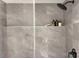 The shower features grey marble tiling and a black shower head at 1033 Harrogate Dr, Bessemer City, NC 28016