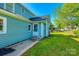 Exterior view of home with well-maintained backyard, lush green grass, and a charming back door at 107 Maurice St, Monroe, NC 28112