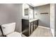 Gray bathroom with modern vanity, mirror, and gray tiled floors at 107 Maurice St, Monroe, NC 28112