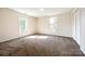 Bedroom features carpet flooring, two windows and a spacious closet at 107 Maurice St, Monroe, NC 28112