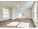 Bright bedroom with plush carpeting, closet, two windows with outside views and modern lighting at 107 Maurice St, Monroe, NC 28112