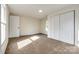Neutral bedroom with closet featuring plush carpeting and natural light from a large window at 107 Maurice St, Monroe, NC 28112