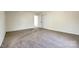 Neutral bedroom with closet featuring plush carpeting, light walls, and access to another room at 107 Maurice St, Monroe, NC 28112