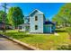 Inviting two-story home with a charming front porch and lush green lawn in a peaceful neighborhood at 107 Maurice St, Monroe, NC 28112