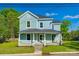 Charming two-story home with a covered front porch and beautiful blue siding at 107 Maurice St, Monroe, NC 28112