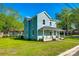 Charming two-story home with front porch, well-manicured lawn, and lush trees at 107 Maurice St, Monroe, NC 28112