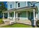 Charming two-story home with a covered front porch and beautiful blue siding at 107 Maurice St, Monroe, NC 28112