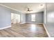 Spacious living room with new floors, large windows, and a ceiling fan at 107 Maurice St, Monroe, NC 28112