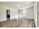 Bright living room featuring wood-look flooring, and natural light from newer windows at 107 Maurice St, Monroe, NC 28112