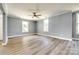 Spacious living room with new floors, large windows, and a ceiling fan at 107 Maurice St, Monroe, NC 28112