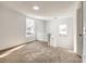 Loft area features carpet flooring, a white railing, and natural light from two windows at 107 Maurice St, Monroe, NC 28112