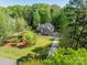Beautiful home with well-manicured lawn, mature trees, and a long driveway at 108 Tall Oak Dr, Mooresville, NC 28117