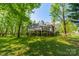 A sprawling backyard with a large deck, mature trees, and lush greenery at 108 Tall Oak Dr, Mooresville, NC 28117