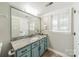 A charming bathroom features a granite countertop and teal-colored cabinetry at 108 Tall Oak Dr, Mooresville, NC 28117