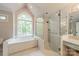 Elegant bathroom featuring a soaking tub with a large window and a glass enclosed shower at 108 Tall Oak Dr, Mooresville, NC 28117
