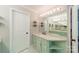 Well-lit bathroom vanity with light green cabinets, quartz countertops, and ample lighting at 108 Tall Oak Dr, Mooresville, NC 28117