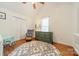 Bedroom with hardwood floors, a rocker, area rug, and dresser with closet at 108 Tall Oak Dr, Mooresville, NC 28117