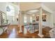 Elegant dining area with large windows, decorative columns, chandelier, and hardwood floors at 108 Tall Oak Dr, Mooresville, NC 28117