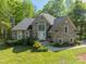 Charming home features a brick facade, arched window above entry, and lush landscaping at 108 Tall Oak Dr, Mooresville, NC 28117