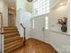 Bright foyer featuring hardwood floors, a staircase, and large windows above the front door at 108 Tall Oak Dr, Mooresville, NC 28117