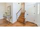 Hallway with wood floors, stairs, a decorative mirror and a side table at 108 Tall Oak Dr, Mooresville, NC 28117