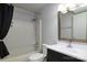 Modern bathroom features a shower-tub combo, complemented by a vanity and dark shower curtain at 11163 Harrowfield Rd # 8198, Charlotte, NC 28226