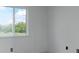 Minimalist bedroom with neutral walls, featuring a window with outside views at 11163 Harrowfield Rd # 8198, Charlotte, NC 28226