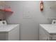 Practical laundry room equipped with side-by-side washer and dryer and wire shelving for added storage at 11163 Harrowfield Rd # 8198, Charlotte, NC 28226