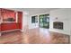 The open concept living room includes a stone fireplace, sliding glass doors leading to the porch and modern flooring at 11163 Harrowfield Rd # 8198, Charlotte, NC 28226