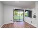 Bright living room with sliding glass doors leading to a porch and a serene outdoor view at 11163 Harrowfield Rd # 8198, Charlotte, NC 28226